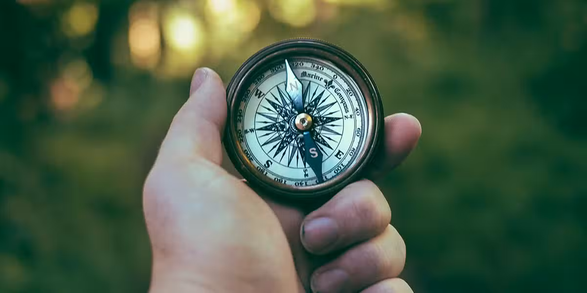 man holding a compass