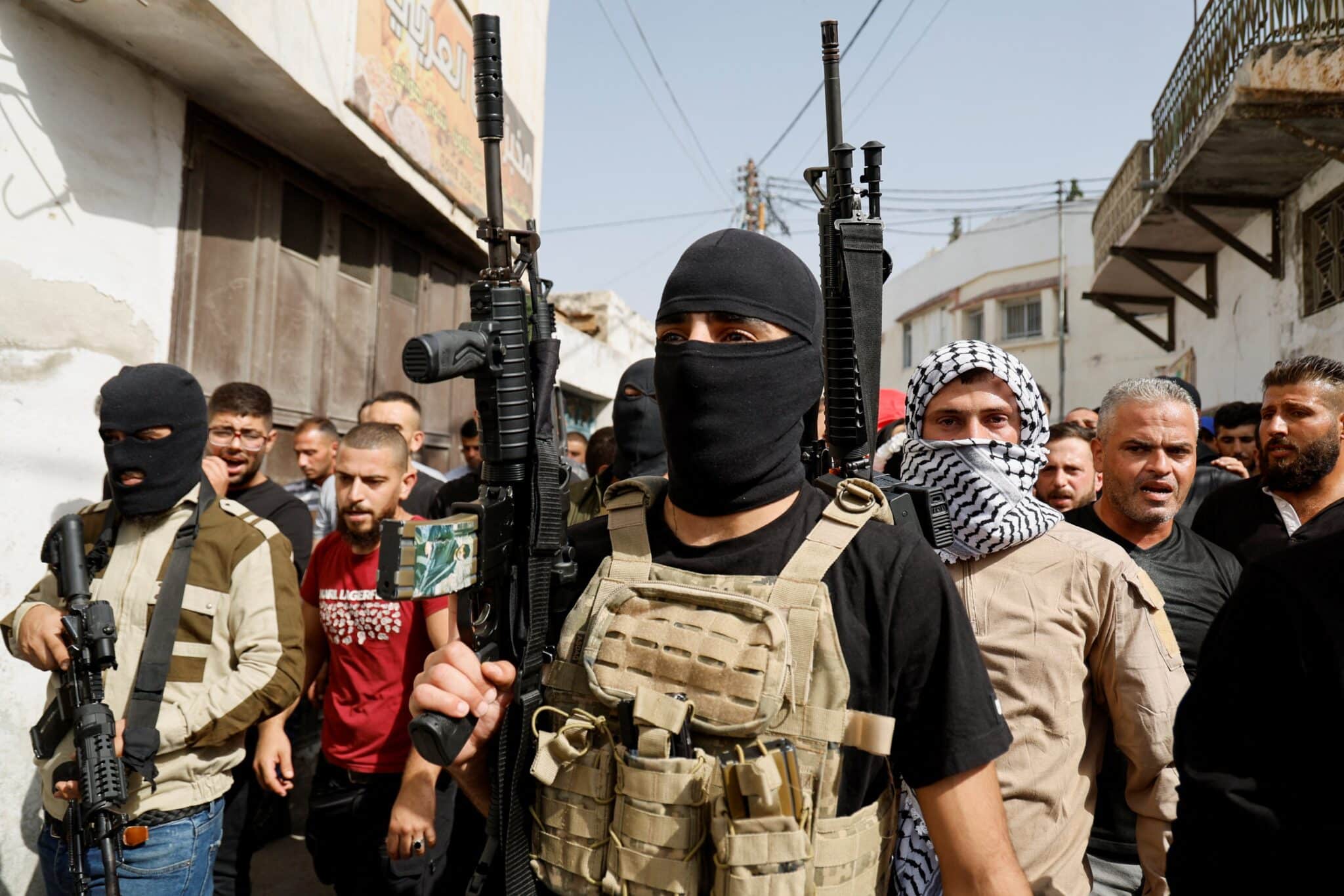 Armed men attend an Oct. 23, 2023, funeral for Palestinians who were killed by Israeli forces near Nablus in the Israeli-occupied West Bank. (OSV News photo/Raneen Sawafta, Reuters)