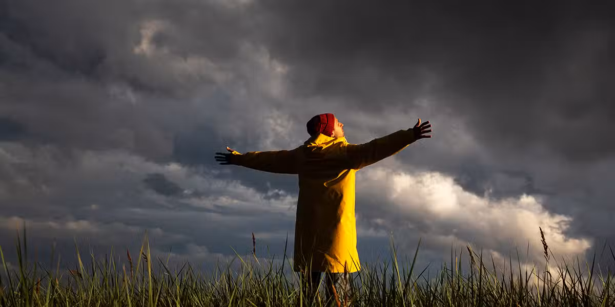 man standing outside during a storm