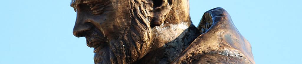 Profile of a bronze statue of Saint Padre Pio