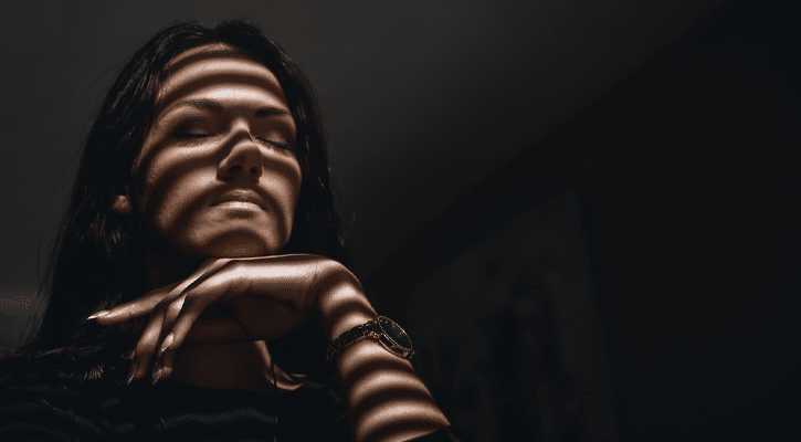 woman with eyes closed and shadows on them